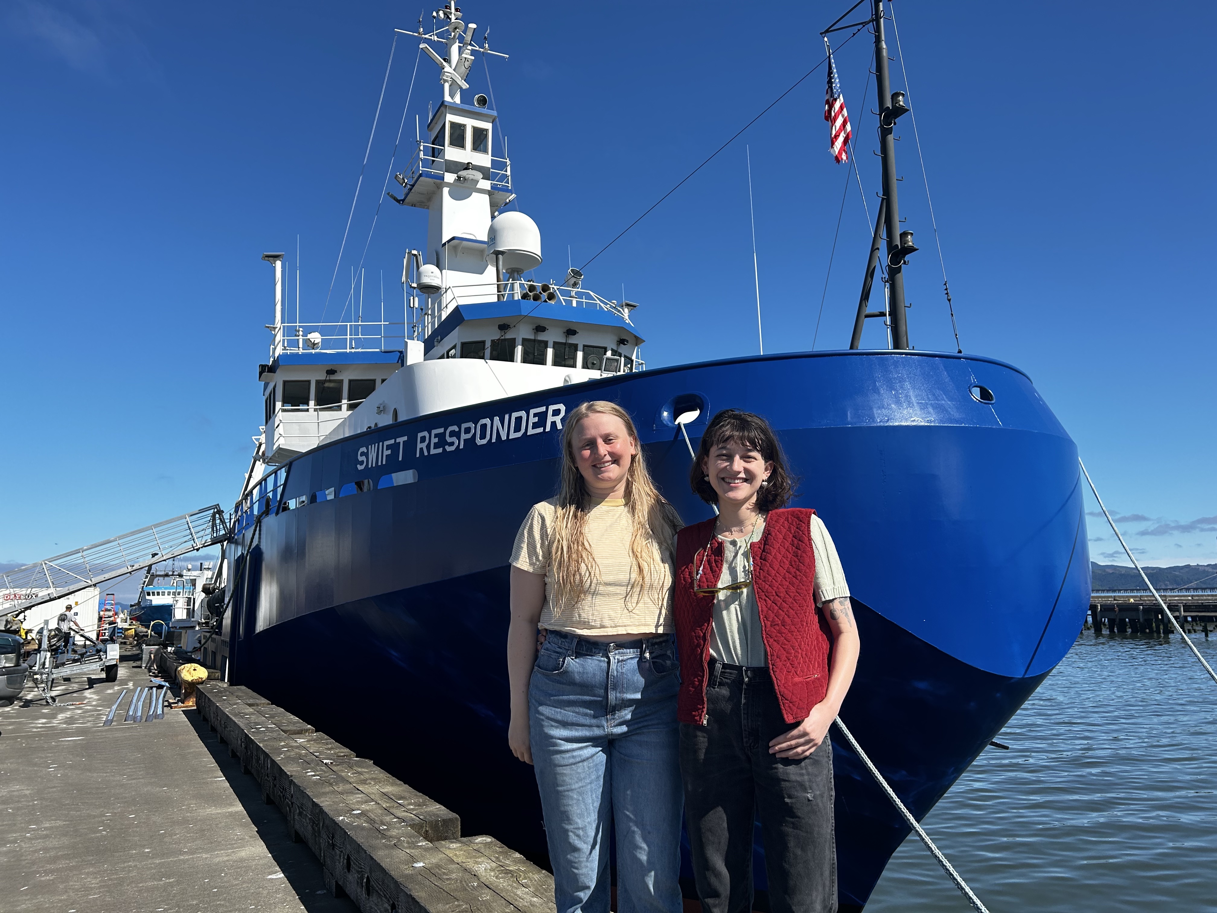 Anna Ledeczi and Madeleine Lucas in front of the R/V Swift Responder in Astoria, OR.